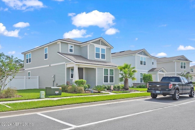 view of front facade featuring a front yard and cooling unit