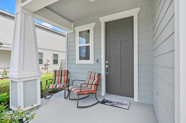 view of exterior entry with a porch