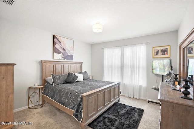 carpeted bedroom with a textured ceiling