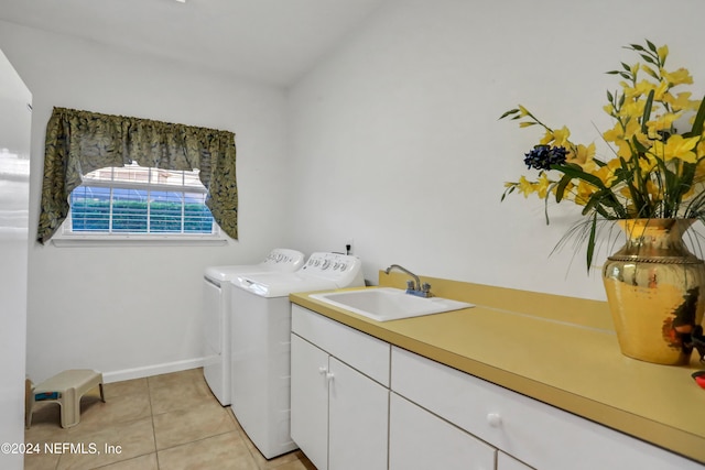 washroom with independent washer and dryer, light tile patterned flooring, cabinets, and sink