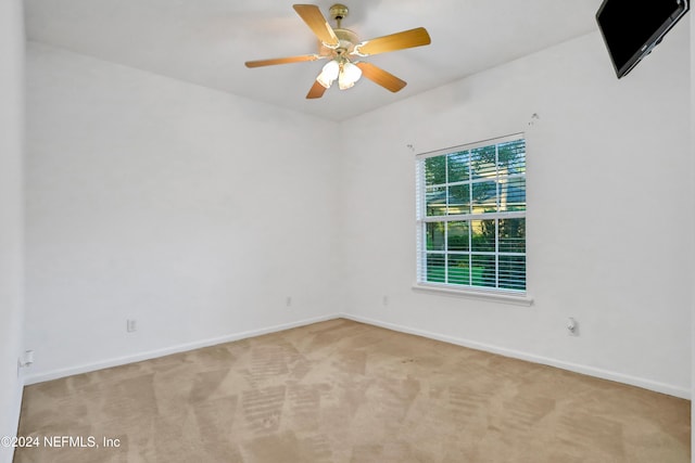 spare room with light carpet and ceiling fan