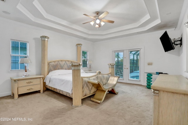 carpeted bedroom with french doors, access to exterior, a tray ceiling, and ceiling fan