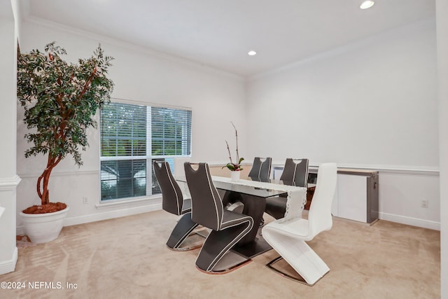 dining area featuring crown molding and light colored carpet