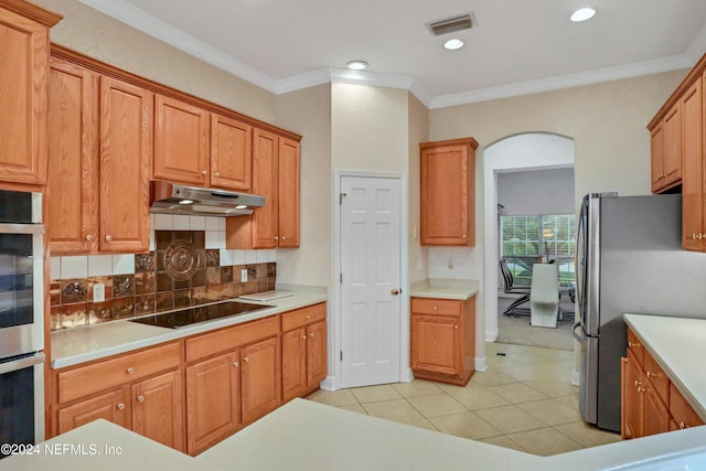 kitchen featuring crown molding, appliances with stainless steel finishes, backsplash, and light tile patterned floors