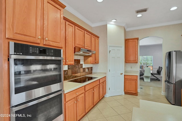 kitchen featuring ornamental molding, appliances with stainless steel finishes, tasteful backsplash, and light tile patterned floors