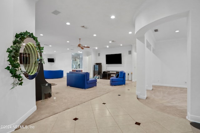 living room featuring light carpet and ceiling fan