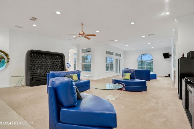 carpeted living room featuring ceiling fan