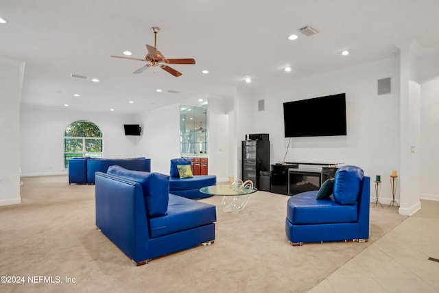 tiled living room with crown molding, a fireplace, and ceiling fan