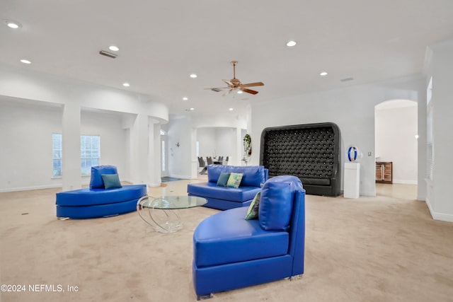 living room featuring light colored carpet and ceiling fan