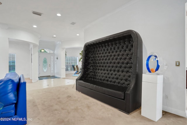 living room featuring ornamental molding and light colored carpet