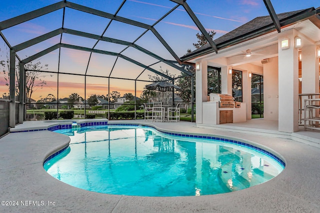 pool at dusk featuring a patio area, glass enclosure, a grill, and ceiling fan