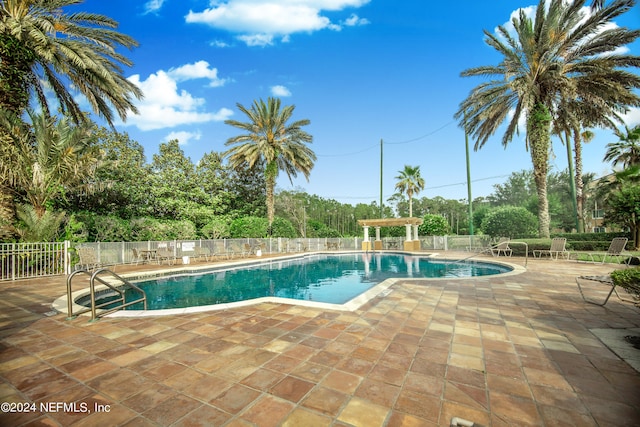 view of swimming pool with a patio