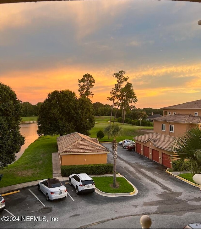 view of front of house featuring a water view and a yard