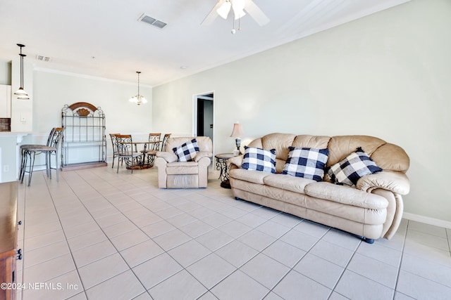 tiled living room featuring crown molding and ceiling fan