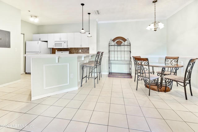 kitchen with white cabinets, pendant lighting, ornamental molding, white appliances, and backsplash