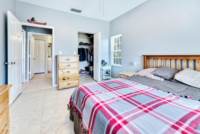 tiled bedroom with a closet