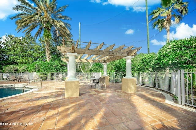 view of patio / terrace with a pergola and a community pool