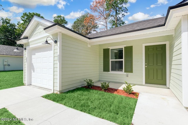 exterior space featuring a porch, a garage, and a front lawn