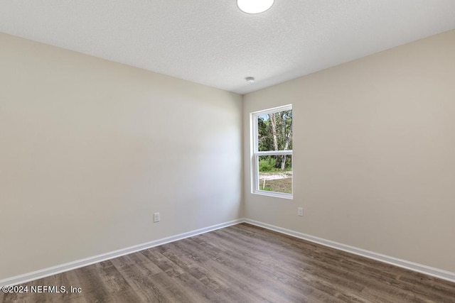 unfurnished room featuring a textured ceiling and wood-type flooring