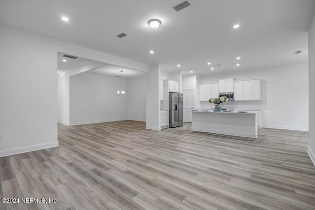 unfurnished living room with light wood-type flooring