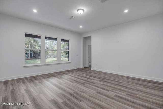 unfurnished room with light hardwood / wood-style floors