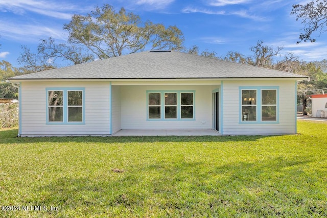 ranch-style house featuring a front lawn and a patio area