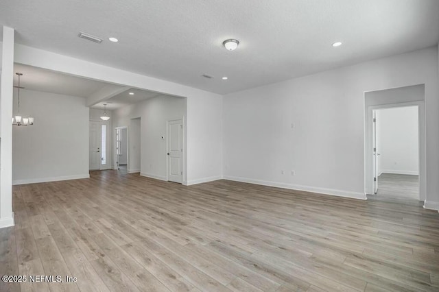 unfurnished living room with a chandelier, recessed lighting, baseboards, and light wood finished floors