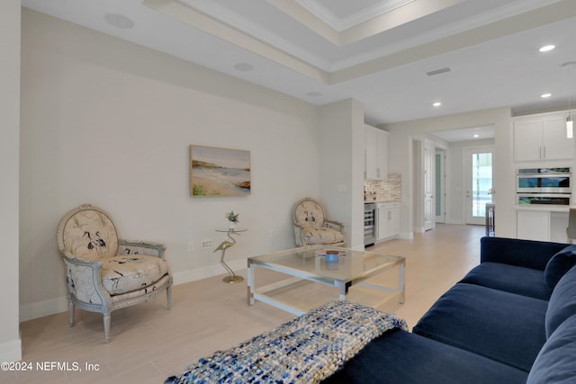 living room with beverage cooler, light hardwood / wood-style flooring, and ornamental molding