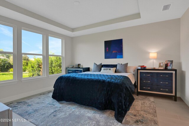 bedroom featuring multiple windows and hardwood / wood-style floors