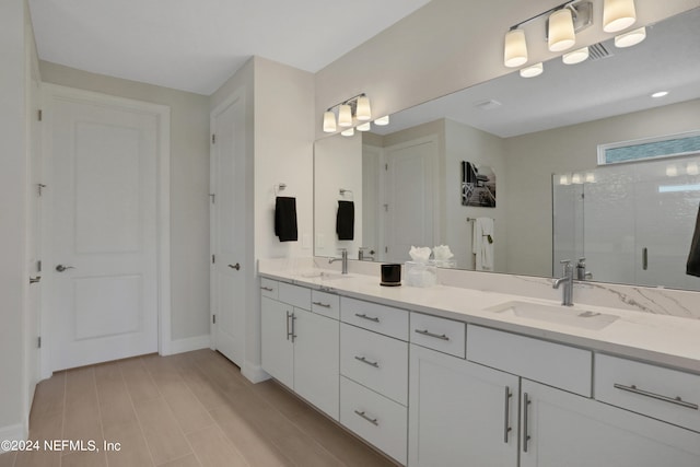 bathroom featuring vanity and an enclosed shower