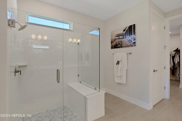 bathroom featuring a shower with shower door