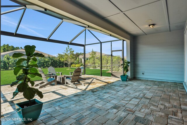 view of patio / terrace featuring glass enclosure