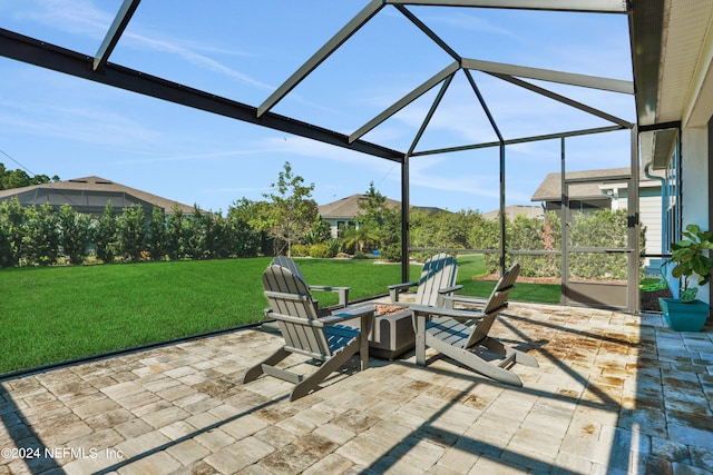 view of patio featuring glass enclosure