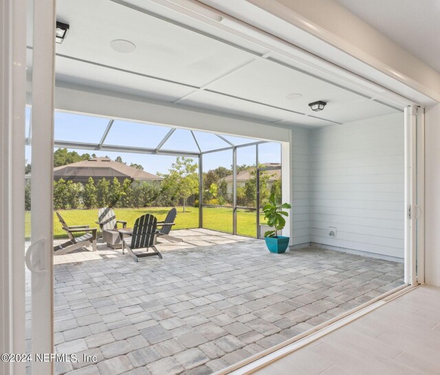 view of patio with glass enclosure