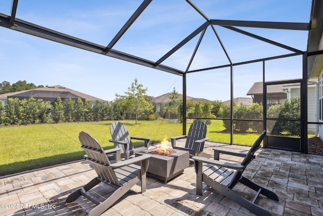 view of patio / terrace with glass enclosure and an outdoor fire pit