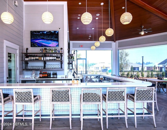 interior space featuring ceiling fan, decorative light fixtures, high vaulted ceiling, wooden ceiling, and hardwood / wood-style floors