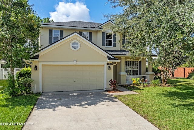 front facade featuring covered porch and a front yard