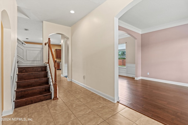 interior space featuring light hardwood / wood-style floors and crown molding