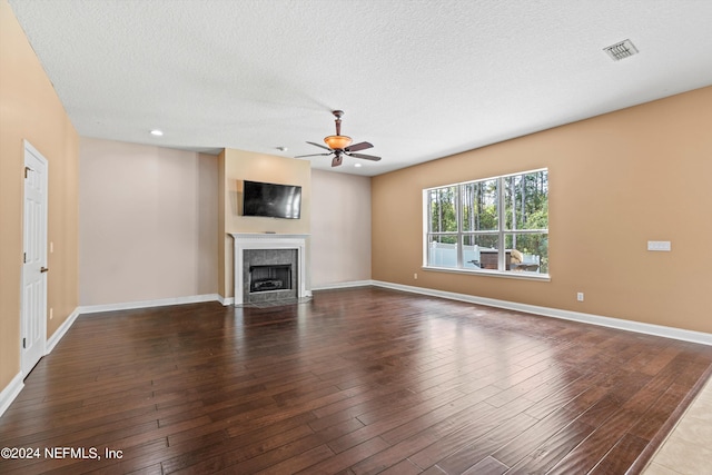 unfurnished living room featuring wood-type flooring, ceiling fan, and a textured ceiling