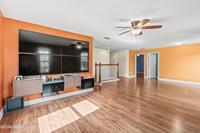 living room with ceiling fan and hardwood / wood-style flooring