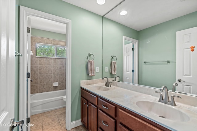 full bathroom with tiled shower / bath, vanity, toilet, and tile patterned floors