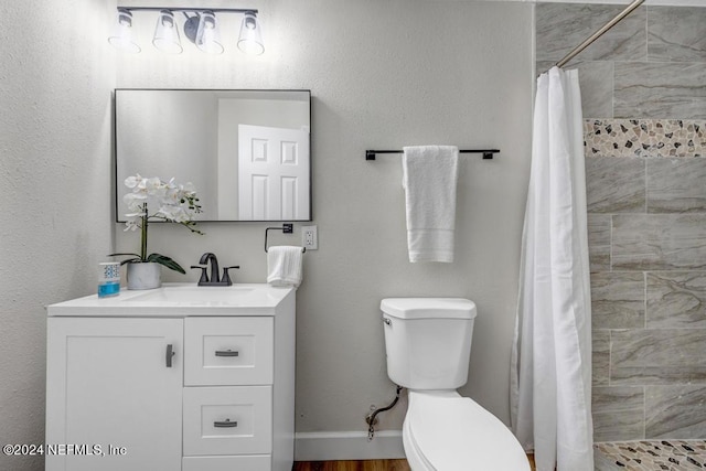 bathroom with curtained shower, wood-type flooring, vanity, and toilet