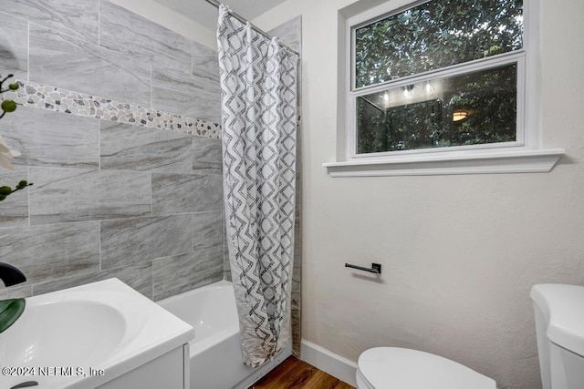 full bathroom featuring hardwood / wood-style floors, vanity, toilet, and shower / bath combination with curtain