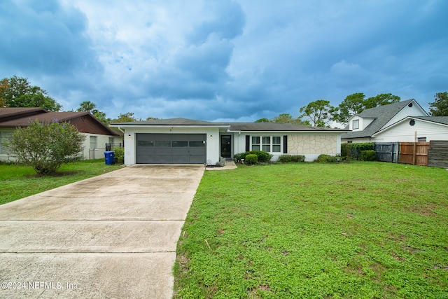 ranch-style home featuring a garage and a front lawn