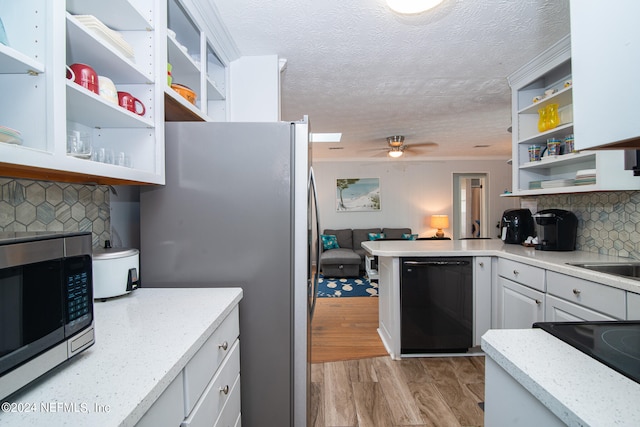 kitchen featuring light wood-type flooring, white cabinets, stainless steel appliances, light stone countertops, and ceiling fan