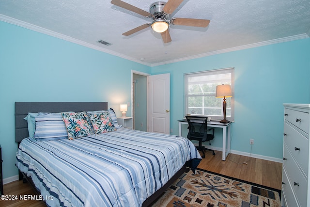 bedroom featuring a textured ceiling, ornamental molding, dark hardwood / wood-style floors, and ceiling fan