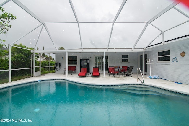 view of swimming pool with a lanai and a patio area