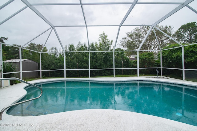 view of pool featuring a storage unit and a lanai