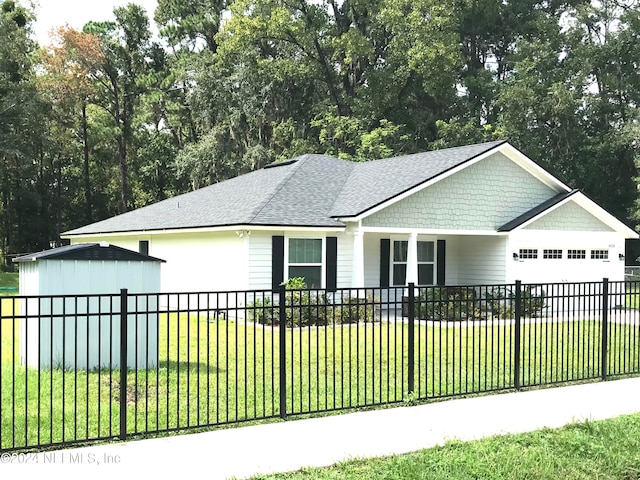 view of front of home with a front yard and a garage