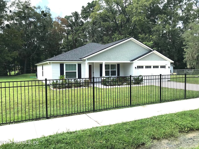 view of front of house with a garage and a front lawn